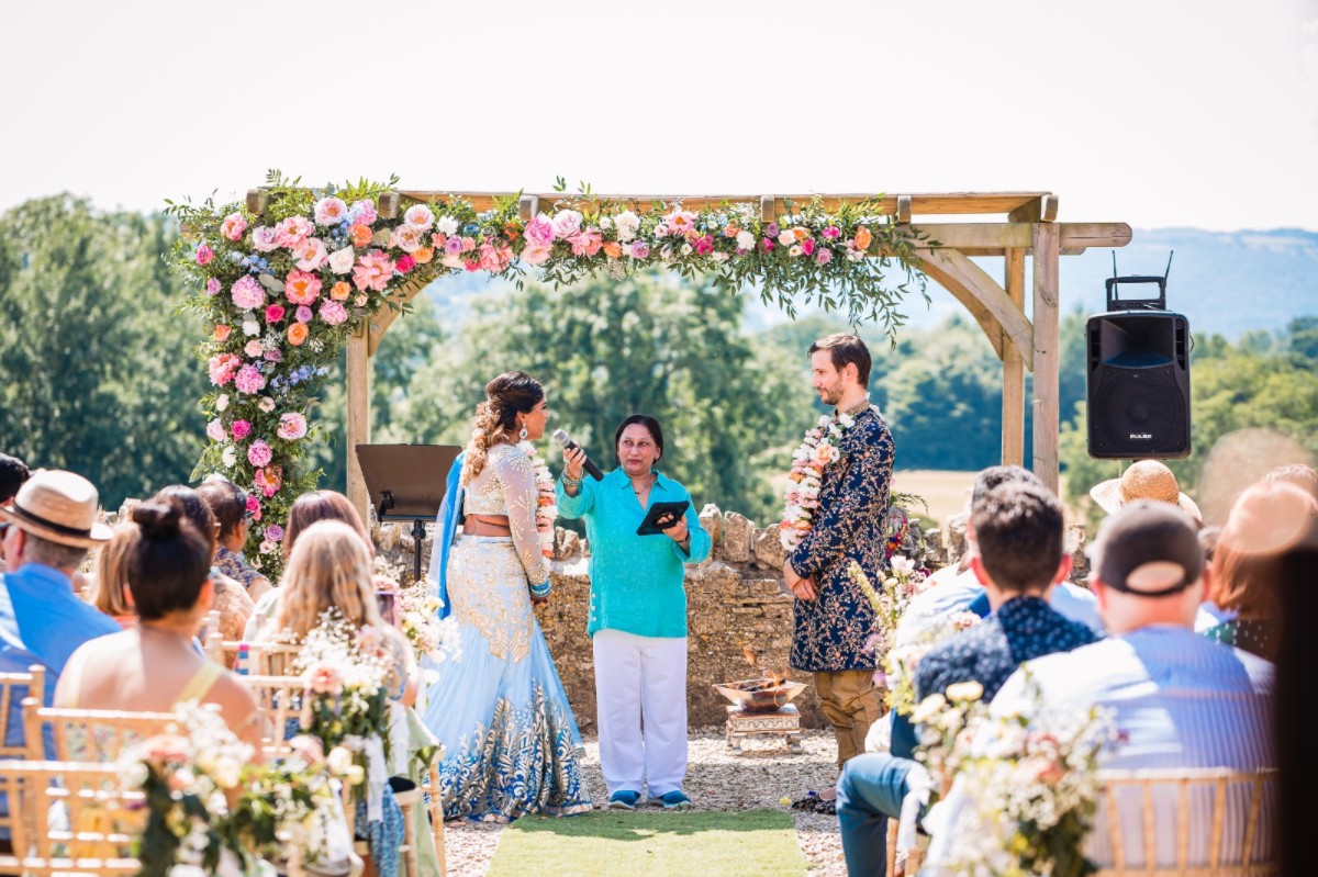 Celebrant officiating wedding ceremony outdoors