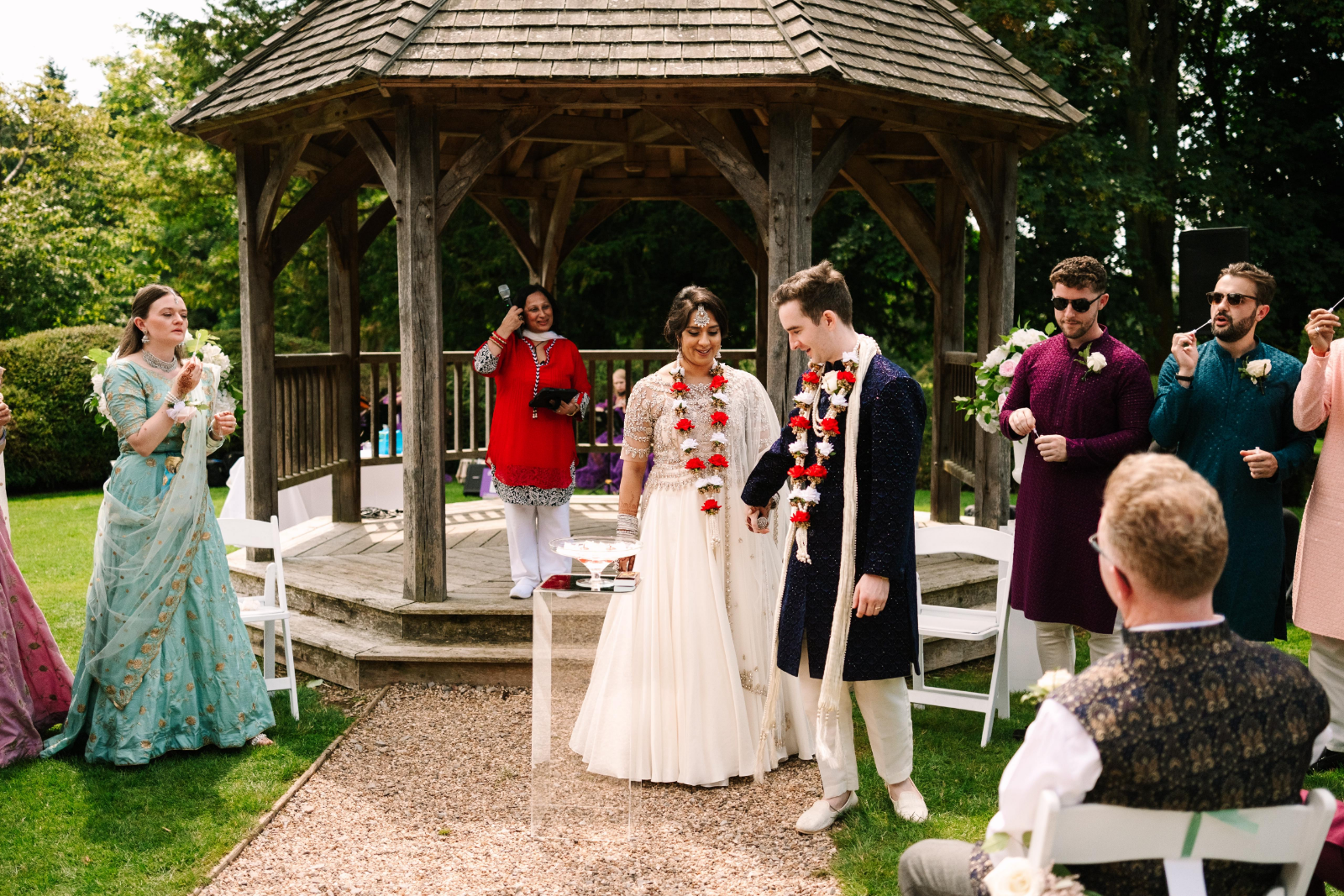multicultural couple at hotel garden wedding ceremony with Asian celebrant