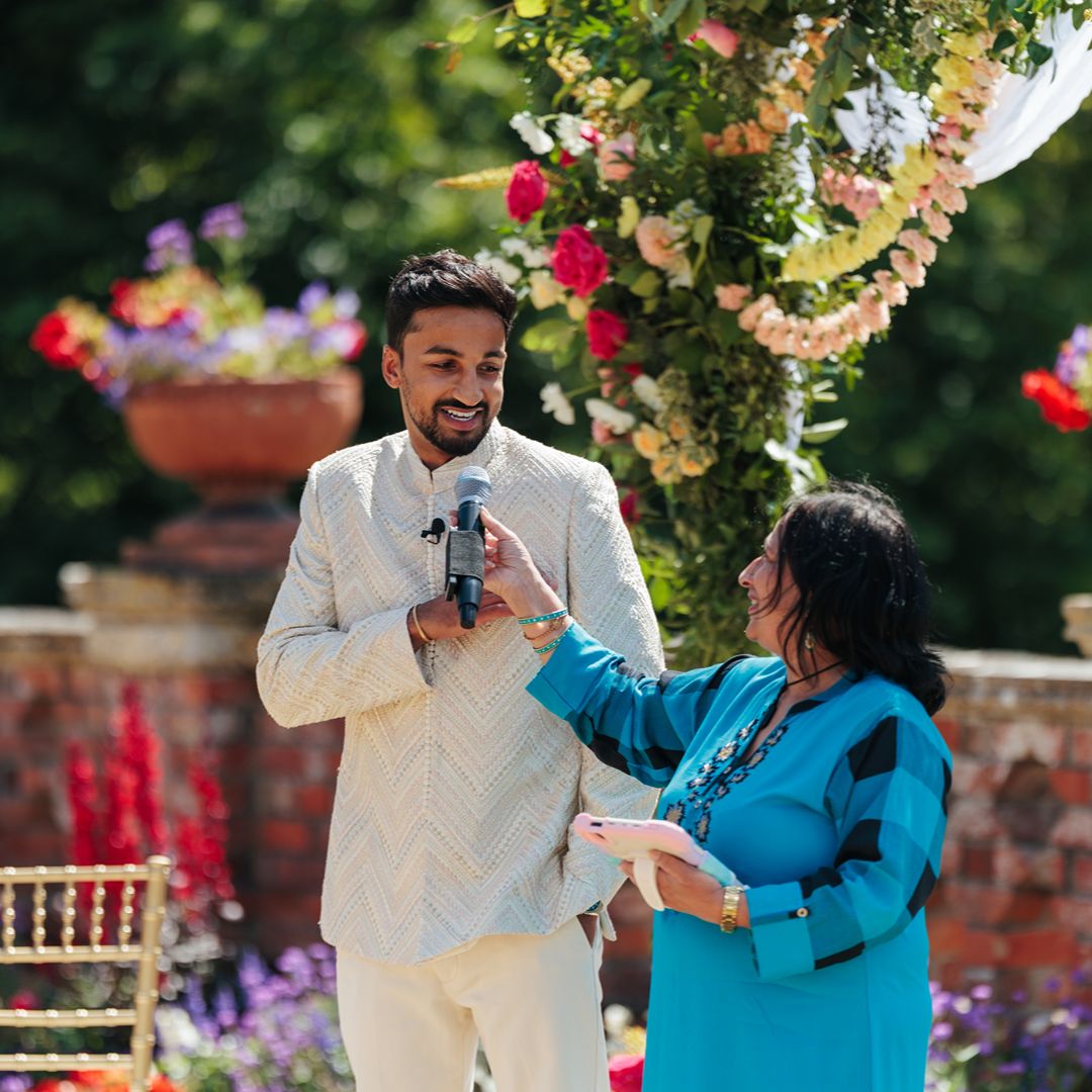 Natasha and Aaron’s celebrant, Sonal Dave leads the couple through their wedding ceremony outdoors, creating a warm and personal moment.